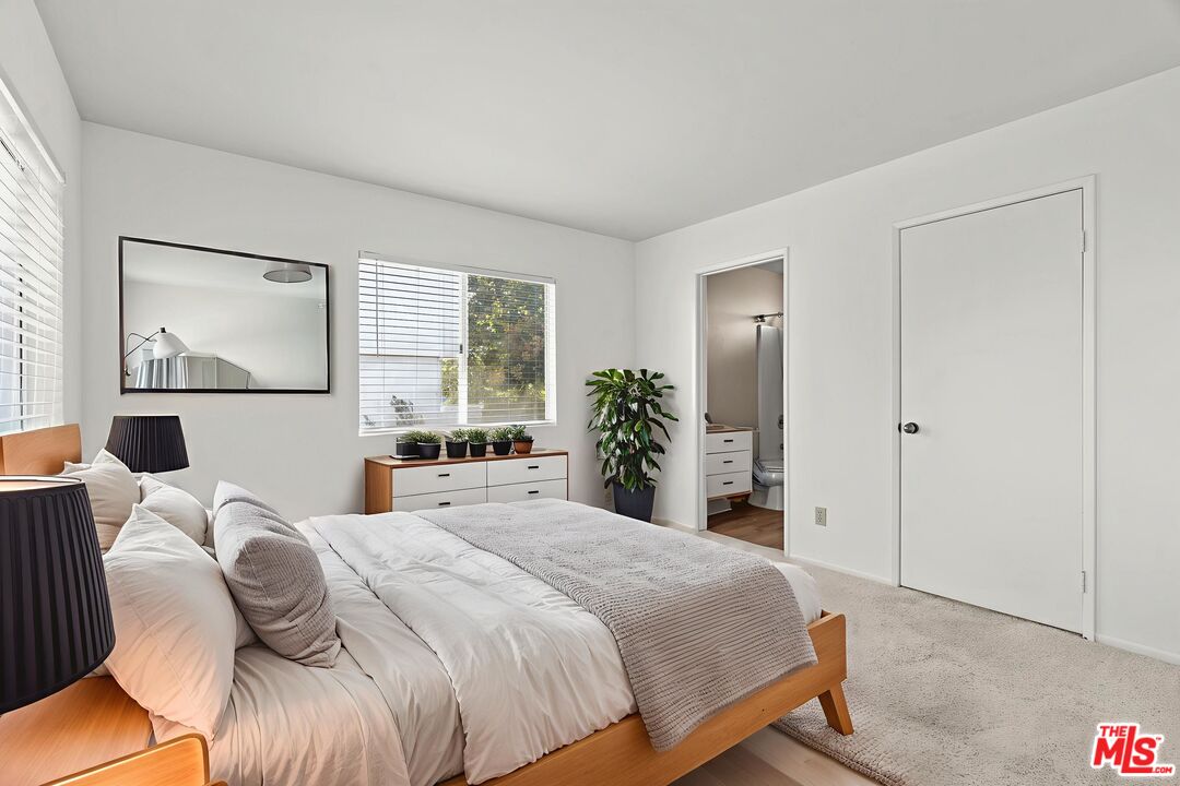 4508 Apricot Road, Unit B Simi Valley, CA 93063 - Photo 9 of 17 a bedroom with a bed and a large mirror