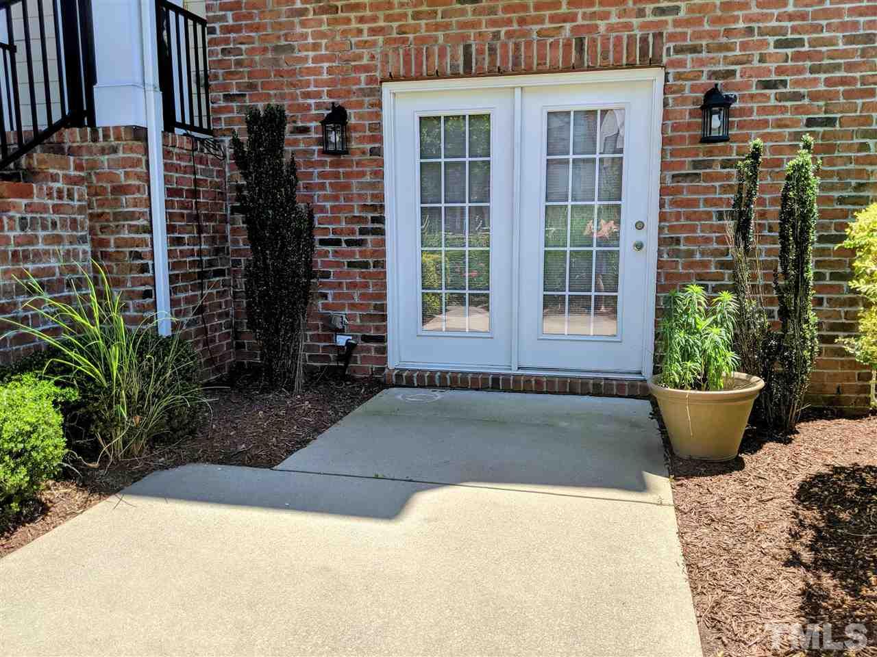 9244 Wooden Road Raleigh, NC 27617 - Photo 6 of 11 Beautiful hardwood staircase with iron railing and archways invite you into the open family, kitchen & breakfast area.