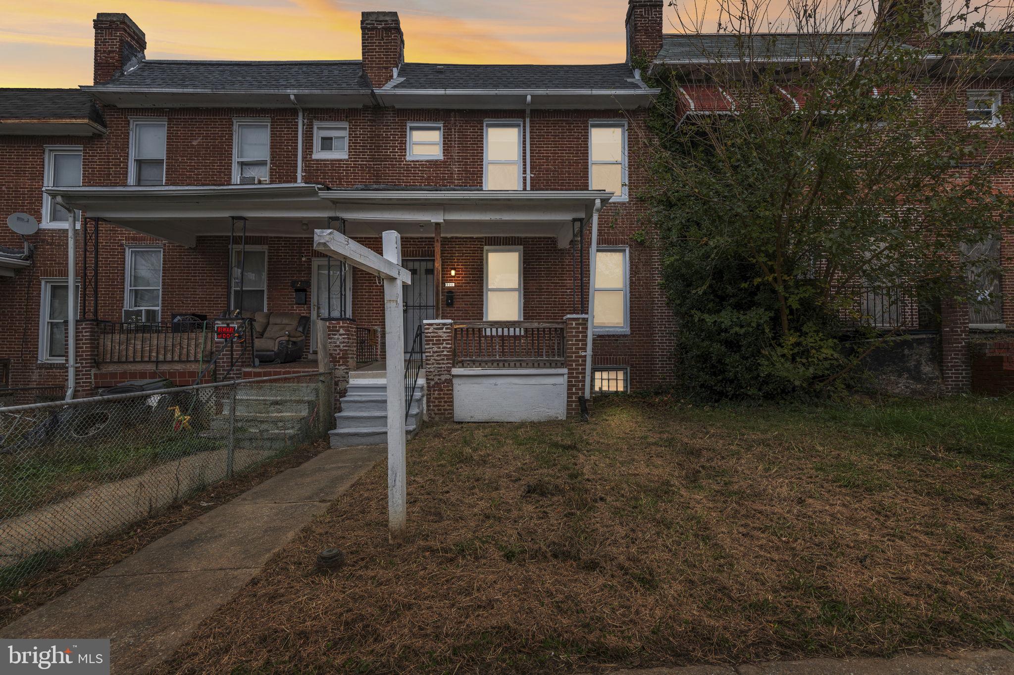 1209 North Dukeland Street Baltimore, MD 21216 - Photo 1 of 21 front view of a house with a yard