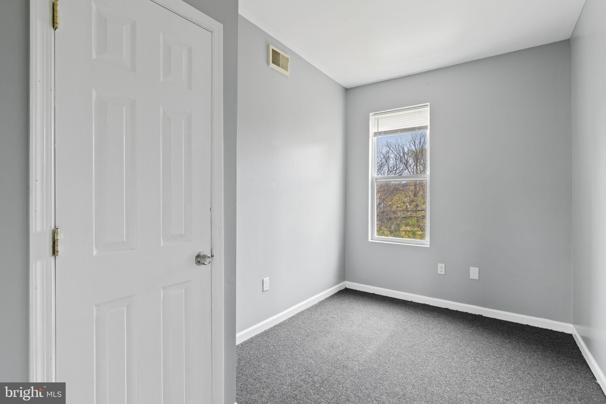 1209 North Dukeland Street Baltimore, MD 21216 - Photo 10 of 21 a view of an empty room with a window