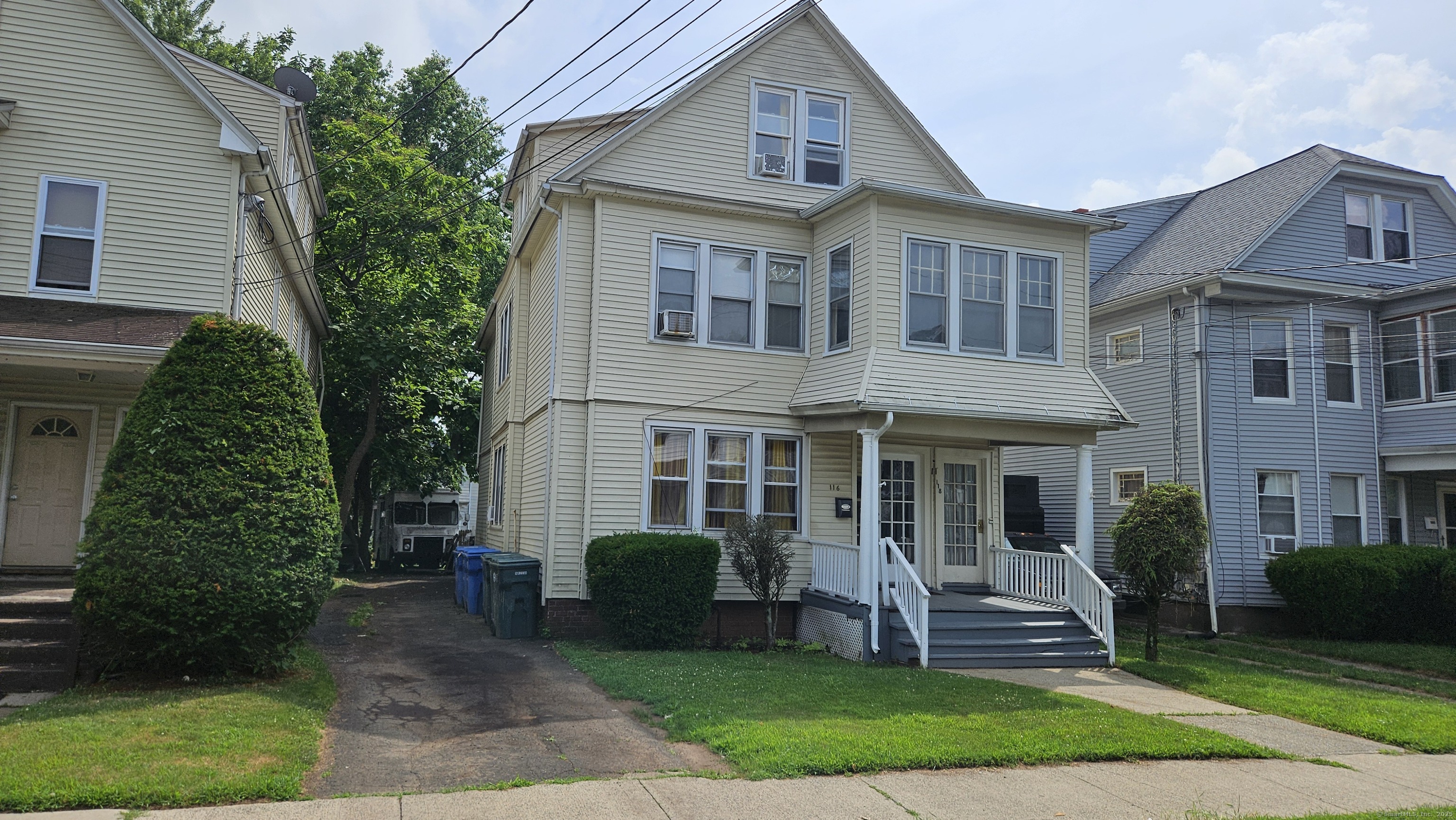 a front view of a house with a yard and trees