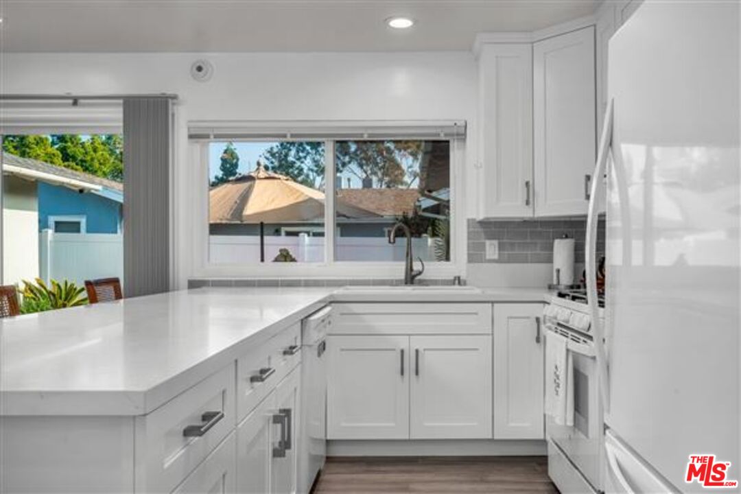 5118 Randall Street Los Angeles, CA 90230 - Photo 13 of 26 a kitchen with white cabinets and window