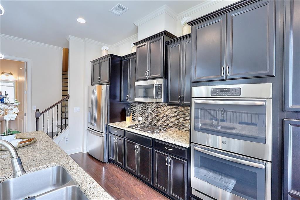 1306 Harris Way South Atlanta, GA 30319 - Photo 2 of 19 a kitchen with stainless steel appliances granite countertop a refrigerator and a stove