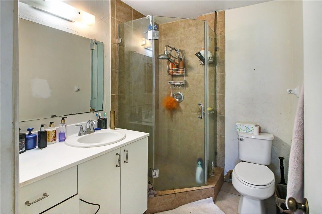 9157 Southwest 5th Street, Unit B Boca Raton, FL 33428 - Photo 12 of 21 a bathroom with a sink toilet and shower