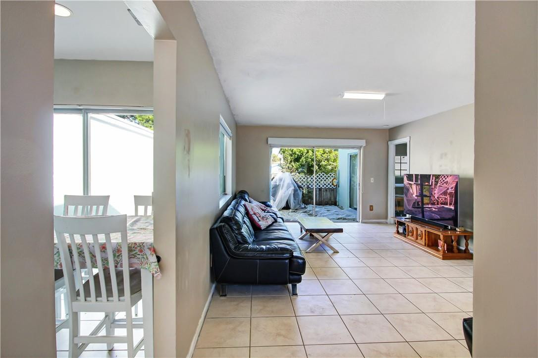 9157 Southwest 5th Street, Unit B Boca Raton, FL 33428 - Photo 2 of 21 a living room with furniture and a flat screen tv
