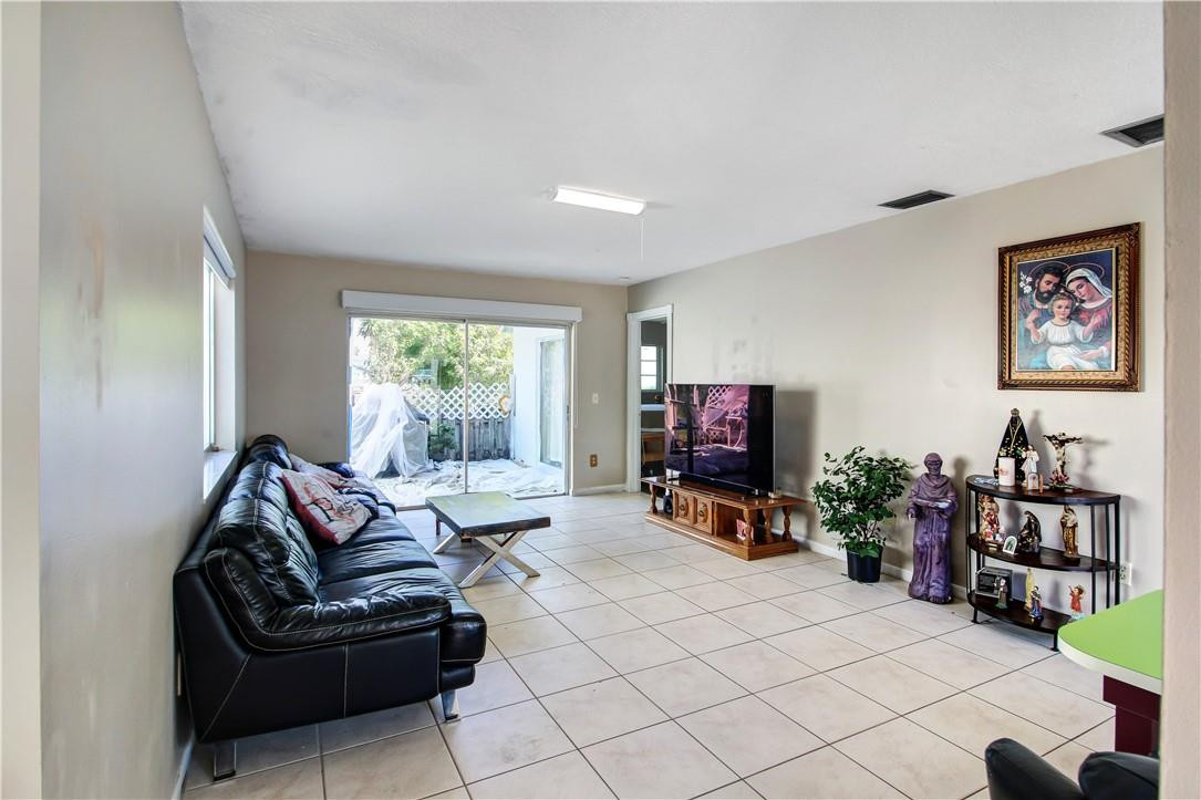 9157 Southwest 5th Street, Unit B Boca Raton, FL 33428 - Photo 3 of 21 a living room with furniture and a flat screen tv