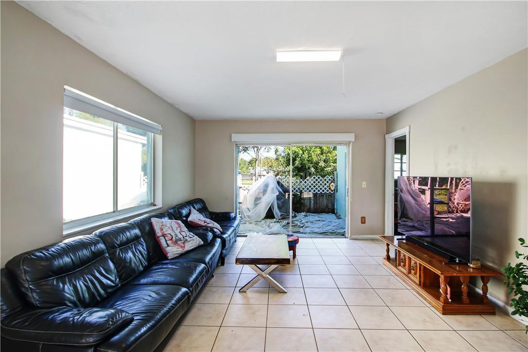 9157 Southwest 5th Street, Unit B Boca Raton, FL 33428 - Photo 4 of 21 a living room with furniture and a flat screen tv