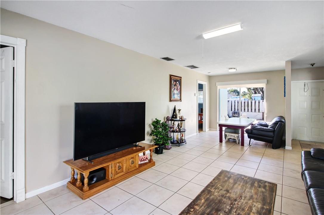 9157 Southwest 5th Street, Unit B Boca Raton, FL 33428 - Photo 5 of 21 a living room with furniture and a flat screen tv