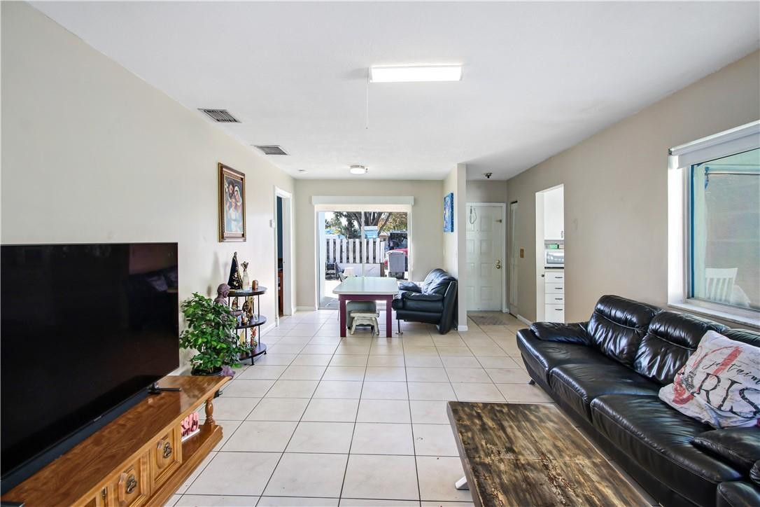 9157 Southwest 5th Street, Unit B Boca Raton, FL 33428 - Photo 6 of 21 a living room with furniture and a flat screen tv