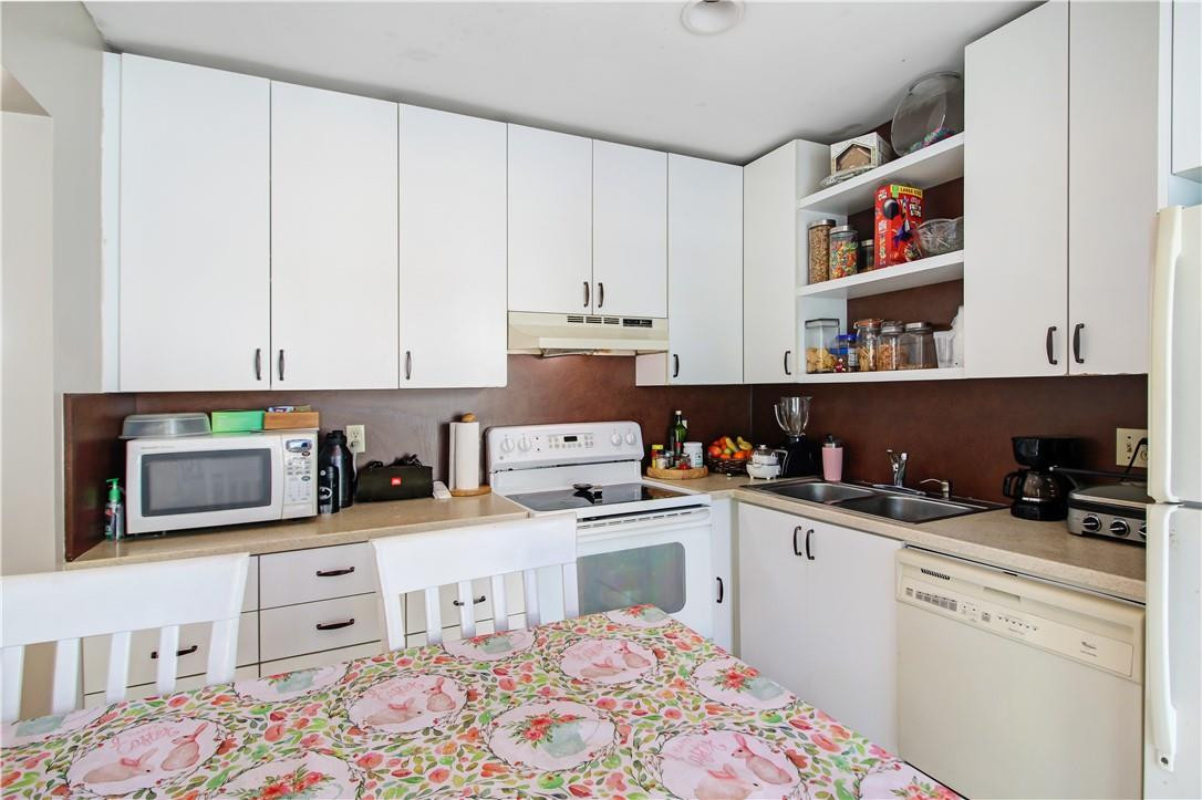 9157 Southwest 5th Street, Unit B Boca Raton, FL 33428 - Photo 8 of 21 a kitchen with stainless steel appliances a cabinets and a counter top space