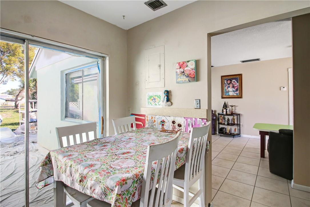 9157 Southwest 5th Street, Unit B Boca Raton, FL 33428 - Photo 9 of 21 a view of a dining room with furniture