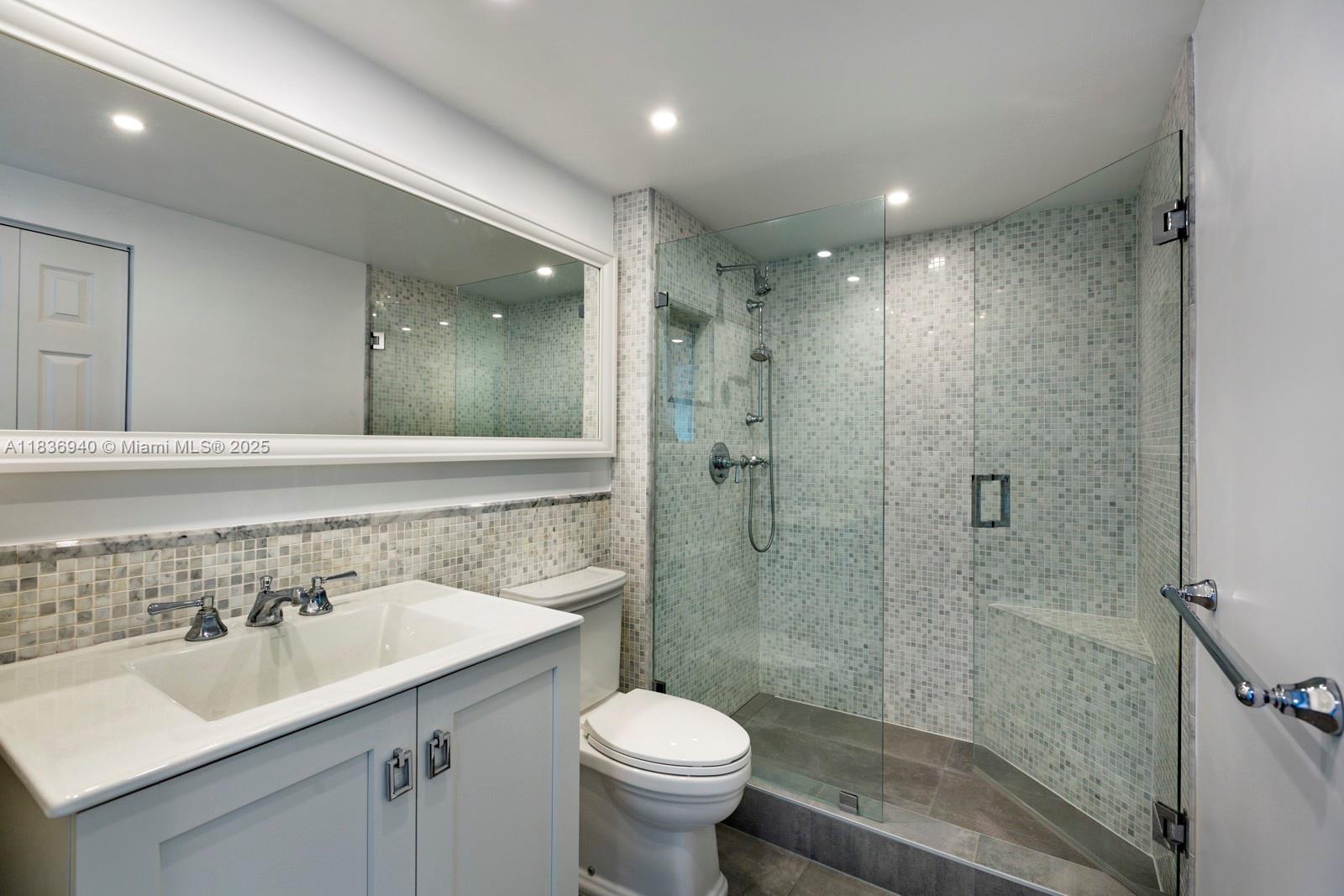 90 Alton Road, Unit 1408 Miami Beach, FL 33139 - Photo 10 of 15 a bathroom with a sink toilet and shower