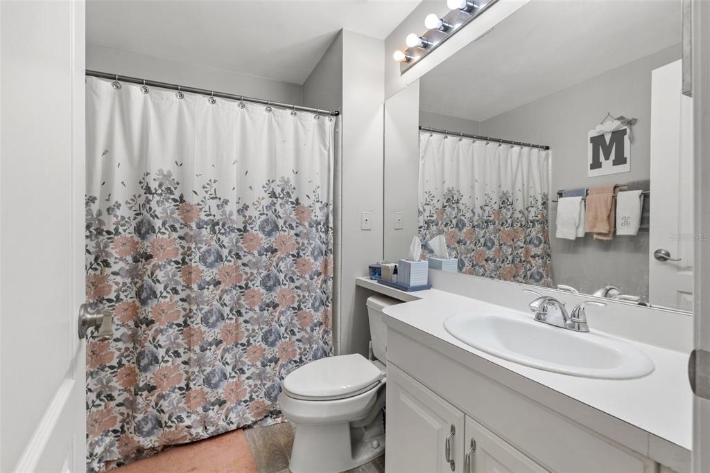 1039 Normandy Trace Road, Unit 1039 Tampa, FL 33602 - Photo 15 of 19 a bathroom with a sink toilet and shower