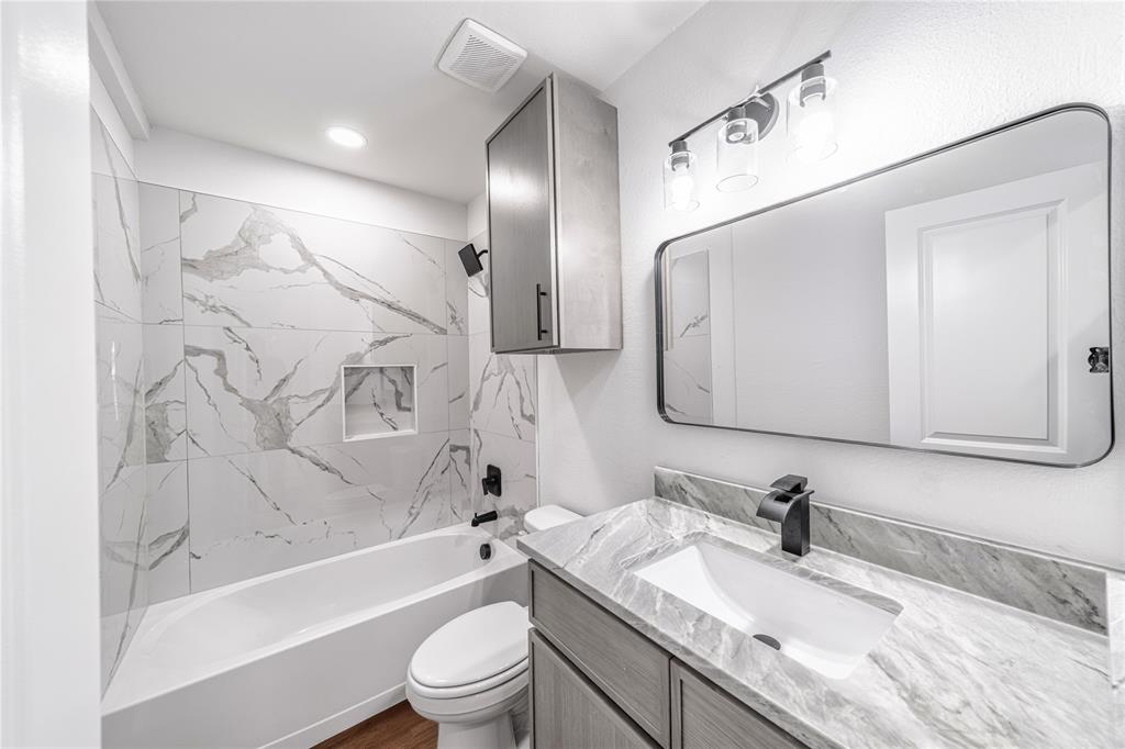 403 Melody Circle Kaufman, TX 75142 - Photo 16 of 25 a bathroom with a granite countertop sink toilet and shower