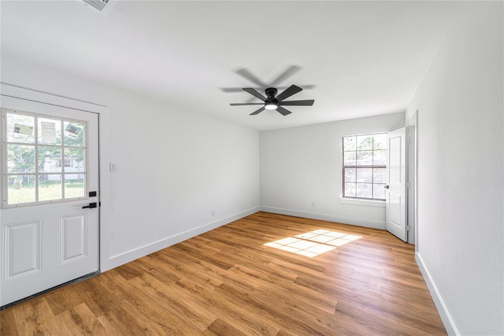 403 Melody Circle Kaufman, TX 75142 - Photo 19 of 25 a view of a big room with wooden floor and windows