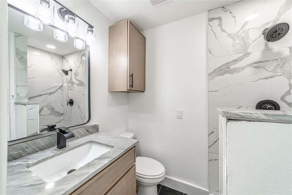 403 Melody Circle Kaufman, TX 75142 - Photo 21 of 25 a bathroom with a granite countertop sink mirror vanity and toilet
