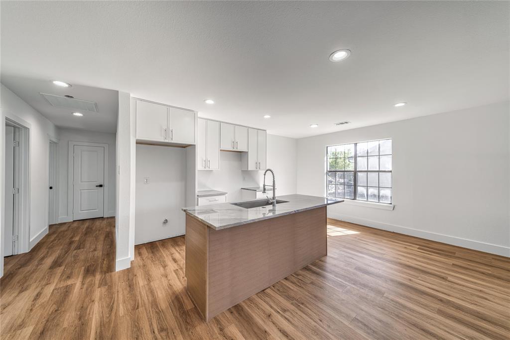 403 Melody Circle Kaufman, TX 75142 - Photo 8 of 25 a kitchen with stainless steel appliances granite countertop a sink and wooden floor