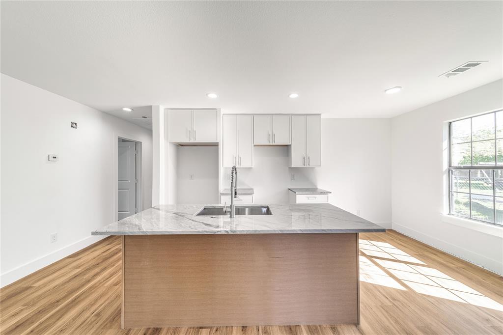 403 Melody Circle Kaufman, TX 75142 - Photo 9 of 25 a kitchen with granite countertop a sink window and cabinets