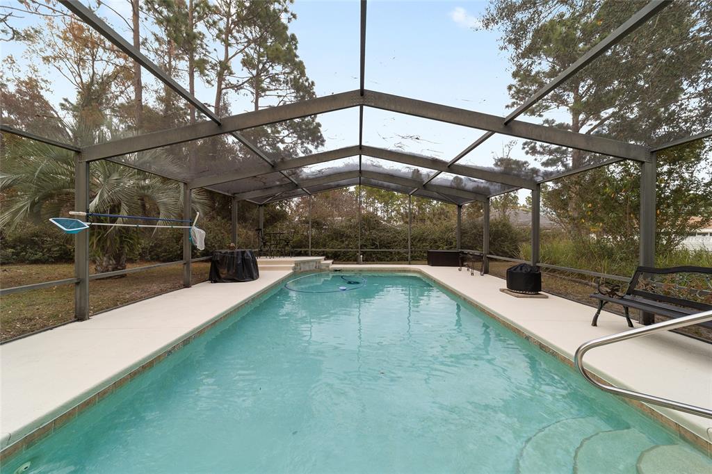 3 Fir Trail Ocala, FL 34472 - Photo 16 of 74 a view of a swimming pool with a patio