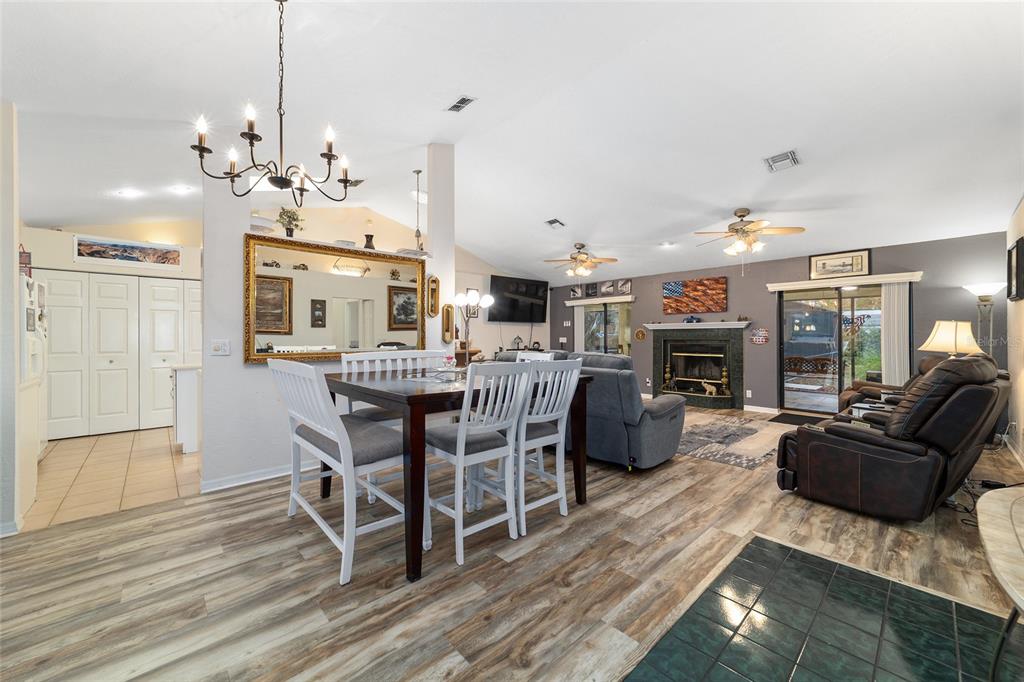 3 Fir Trail Ocala, FL 34472 - Photo 25 of 74 a living room with furniture a fireplace and a chandelier