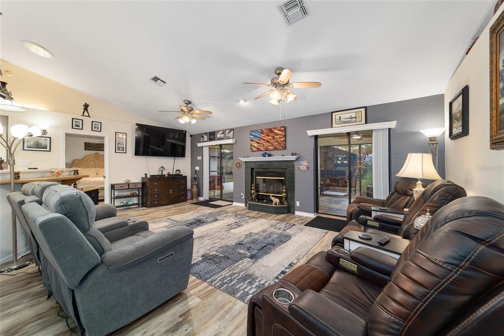 3 Fir Trail Ocala, FL 34472 - Photo 26 of 74 a living room with furniture a fireplace and a flat screen tv