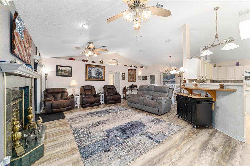 3 Fir Trail Ocala, FL 34472 - Photo 30 of 74 a living room with furniture a fireplace and a chandelier