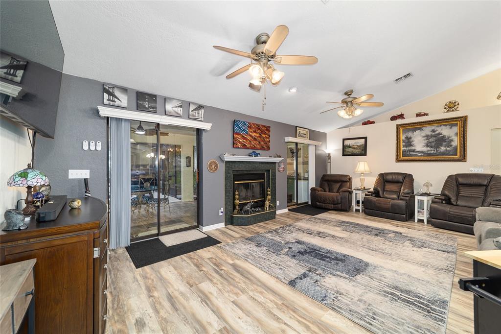 3 Fir Trail Ocala, FL 34472 - Photo 32 of 74 a living room with furniture a fireplace and a chandelier