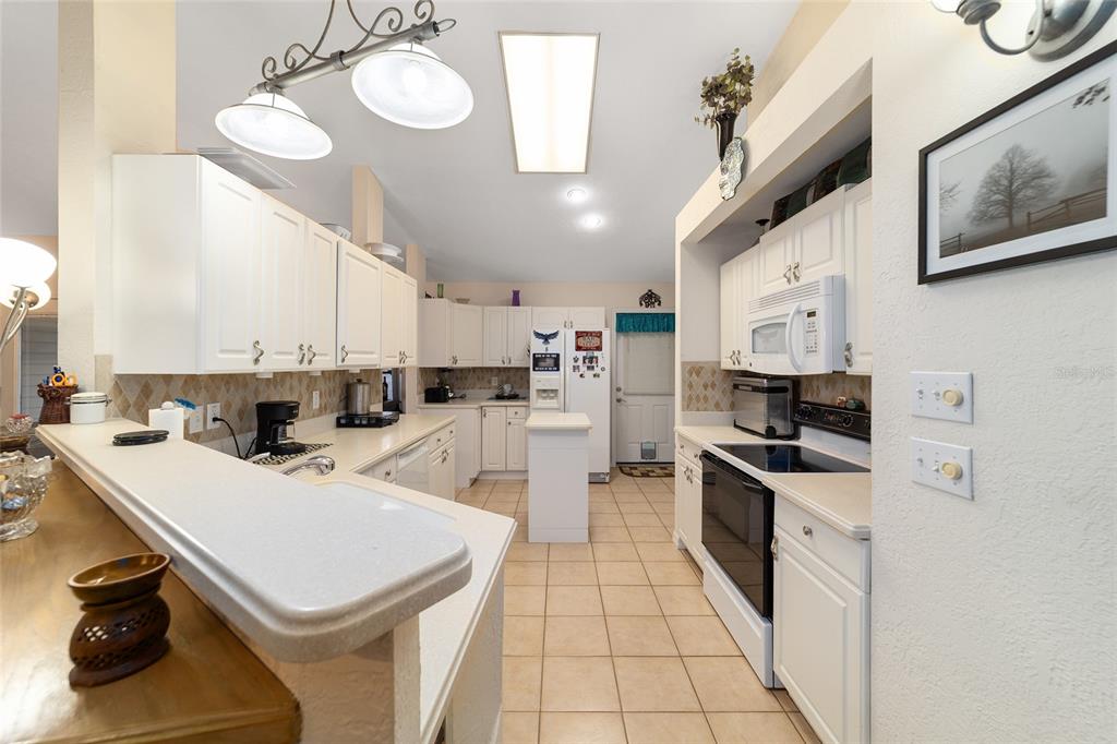 3 Fir Trail Ocala, FL 34472 - Photo 38 of 74 a kitchen with a sink a stove and cabinets