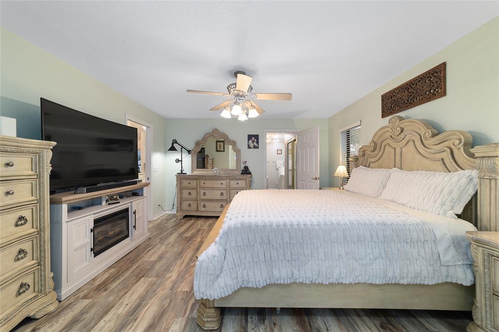3 Fir Trail Ocala, FL 34472 - Photo 41 of 74 a spacious bedroom with a bed and a flat screen tv