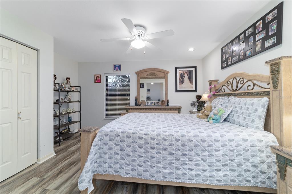 3 Fir Trail Ocala, FL 34472 - Photo 53 of 74 a bedroom with a large bed and a chandelier