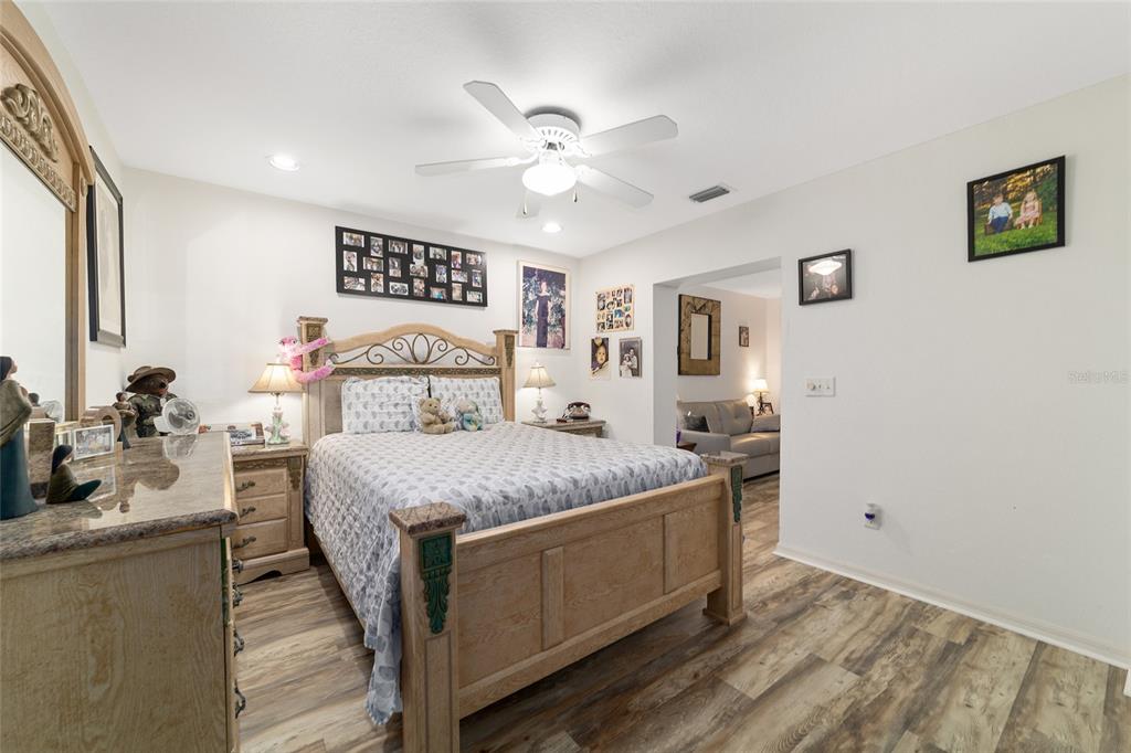 3 Fir Trail Ocala, FL 34472 - Photo 54 of 74 a bedroom with a bed and a chandelier