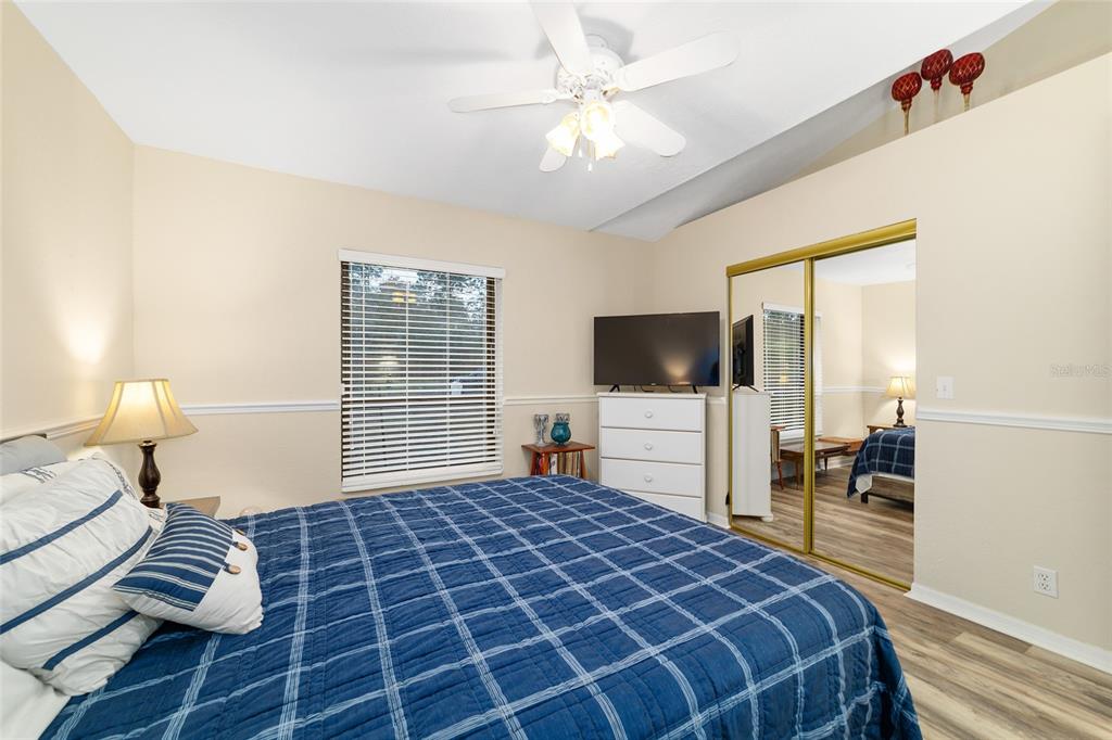 3 Fir Trail Ocala, FL 34472 - Photo 58 of 74 a bedroom with a large bed and a flat tv screen on dresser