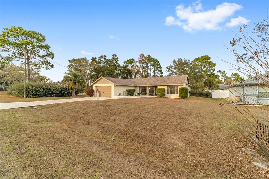 3 Fir Trail Ocala, FL 34472 - Photo 71 of 74 a front view of a house with a yard and garage