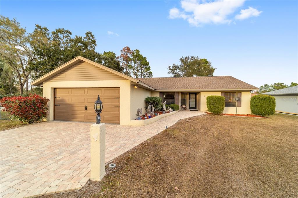 3 Fir Trail Ocala, FL 34472 - Photo 73 of 74 a front view of a house with a garden