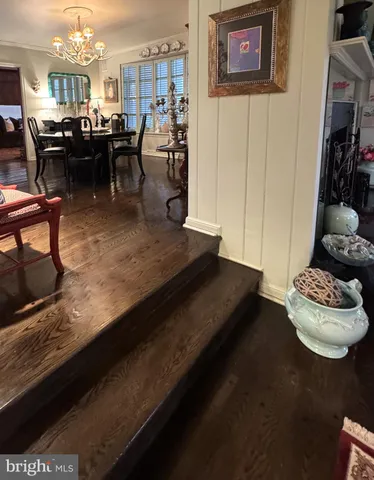 a living room with lots of furniture and a painting on the wall