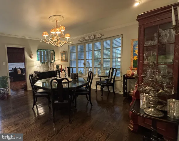 a view of a dining room with furniture and chandelier