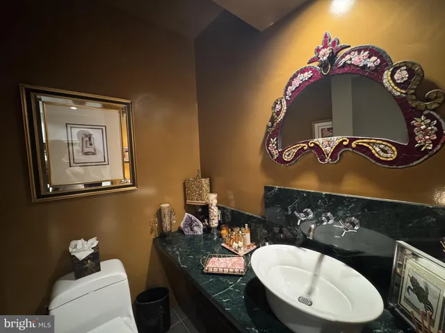 a bathroom with a toilet a sink and mirror