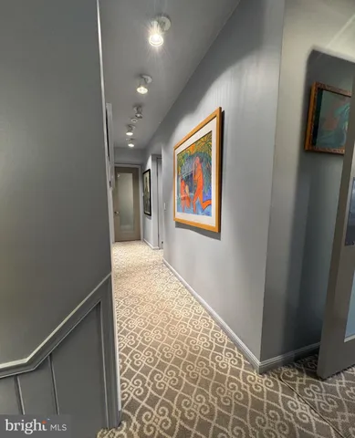 a view of a room with a refrigerator and a window