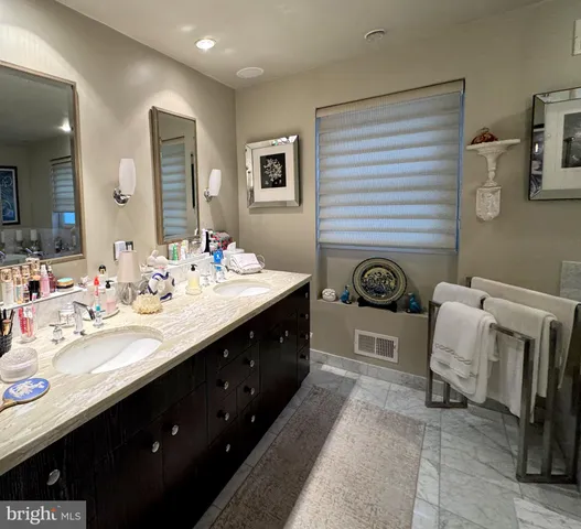 a bed sitting in a bedroom and chair