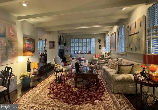 a living room with furniture or couch and a wooden floor