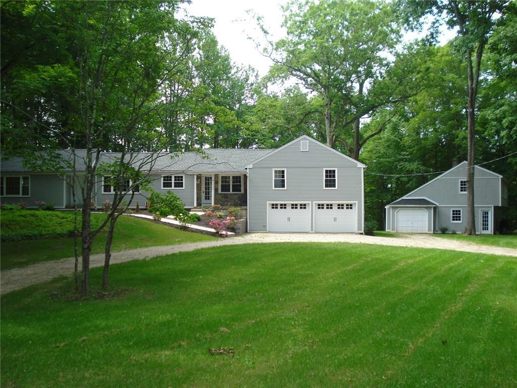 a front view of a house with yard and green space