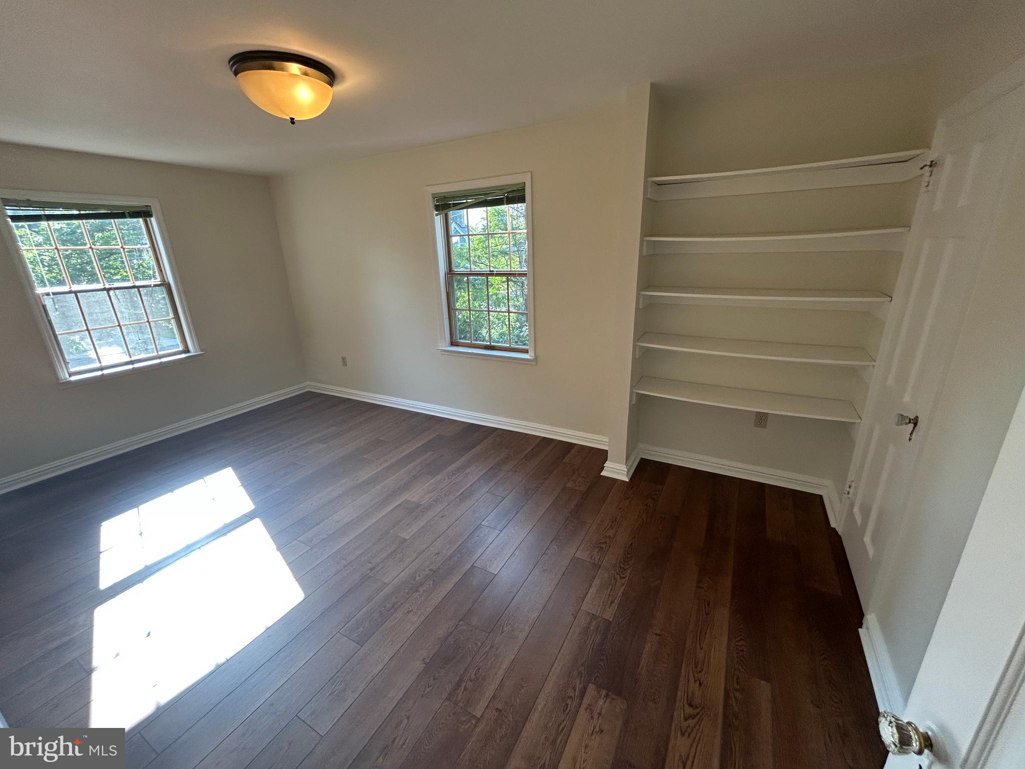 214 Grayling Avenue, Unit ONE Narberth, PA 19072 - Photo 14 of 22 wooden floor in an empty room with a window