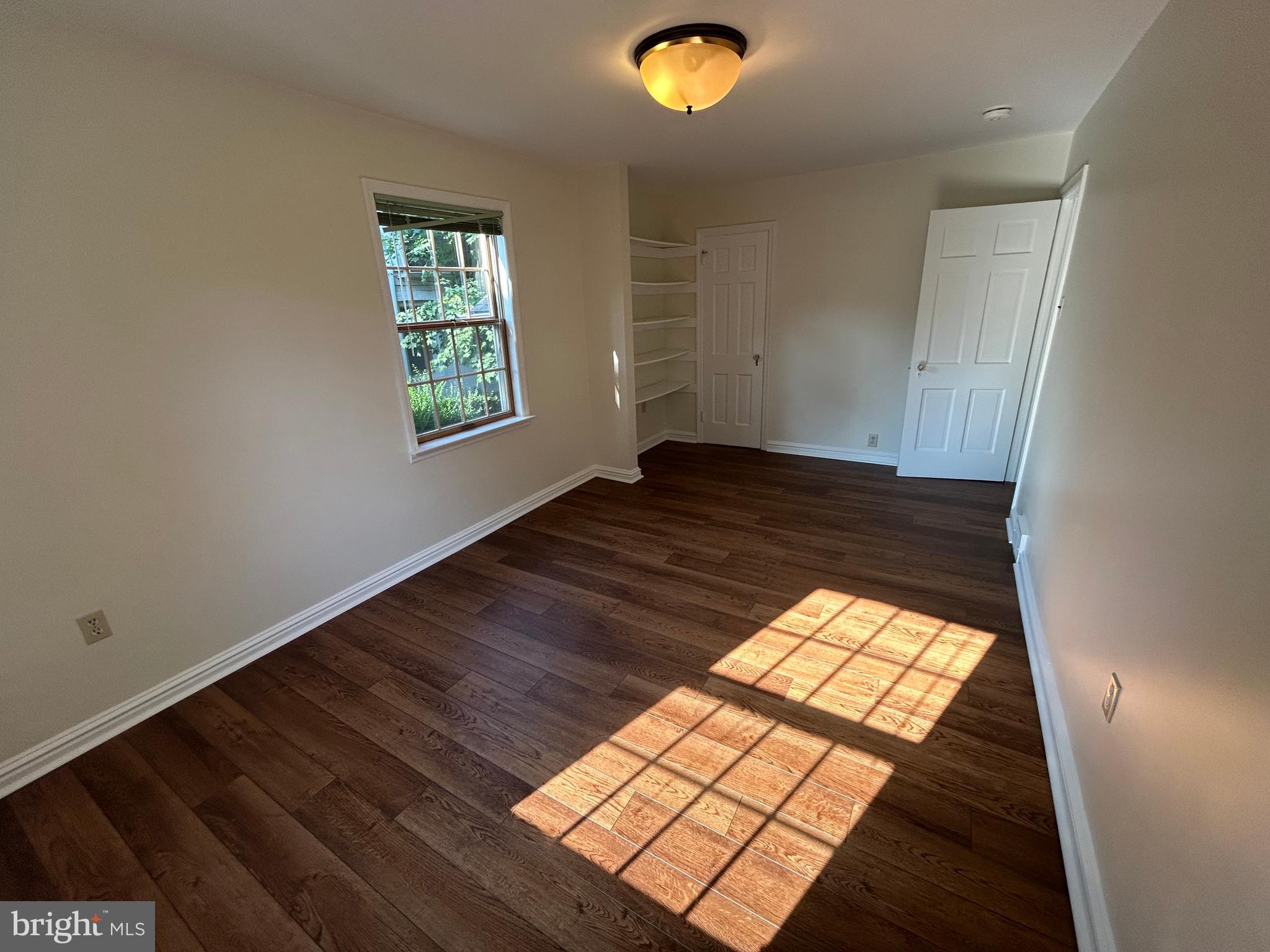 214 Grayling Avenue, Unit ONE Narberth, PA 19072 - Photo 15 of 22 an empty room with wooden floor windows and view