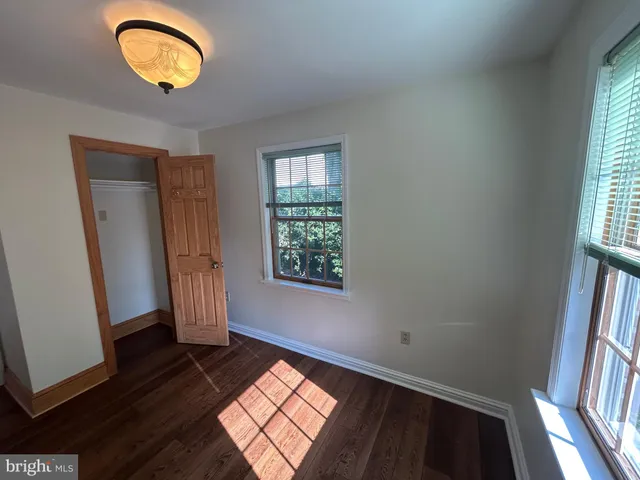 an entryway with a window and wooden floor