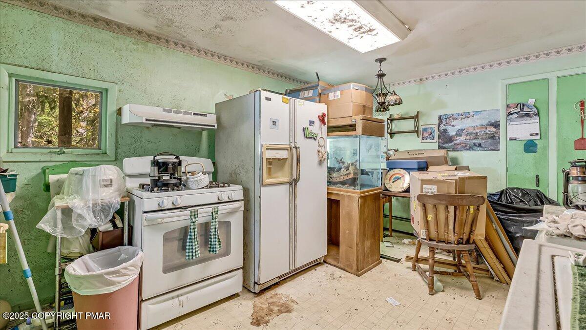 202 Price Road Stroudsburg, PA 18360 - Photo 11 of 45 a view of a kitchen with fridge and workspace