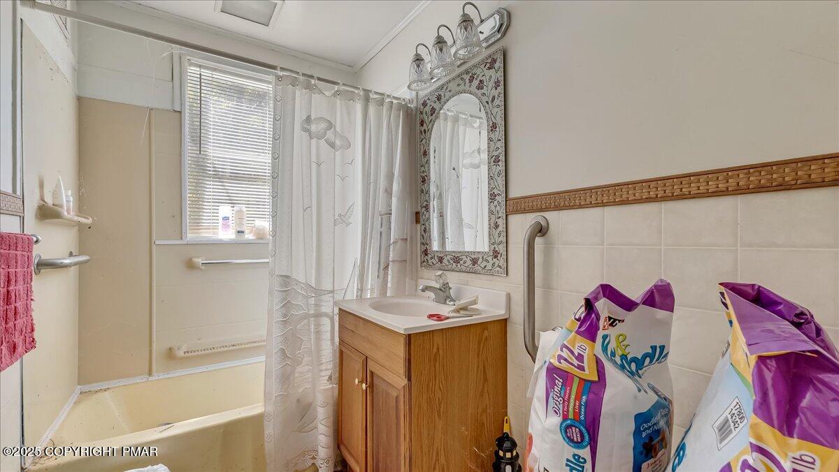 202 Price Road Stroudsburg, PA 18360 - Photo 17 of 45 a bathroom with a tub sink and a shower curtain