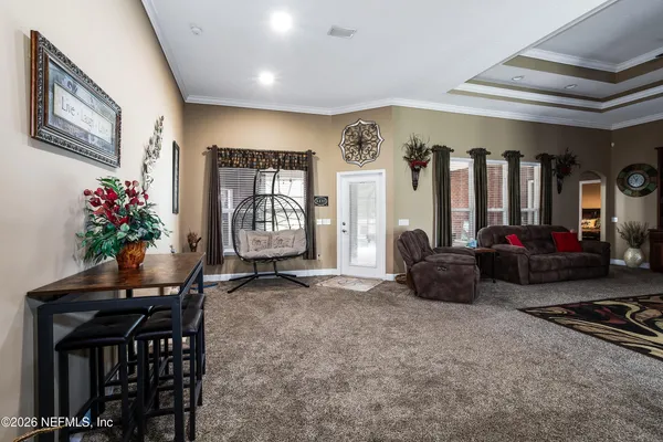 a living room with furniture a piano and a flat screen tv
