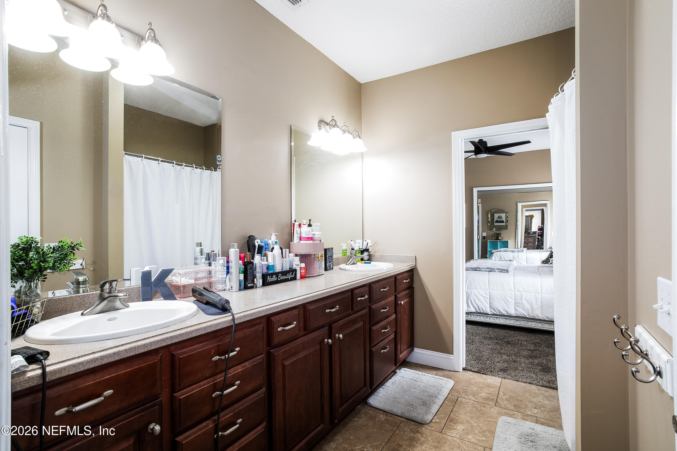 3795 Raintree Drive Macclenny, FL 32063 - Photo 15 of 40 a bathroom with a double vanity sink and a mirror