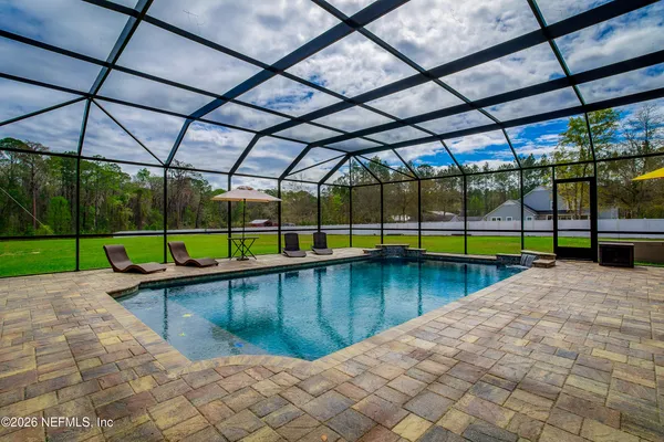 a view of a backyard with a swimming pool