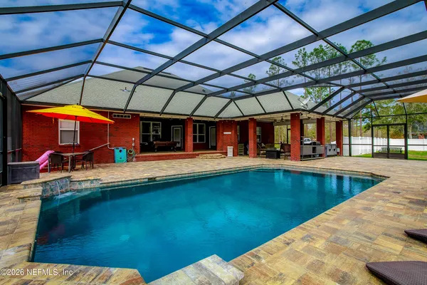 a view of a swimming pool with a patio